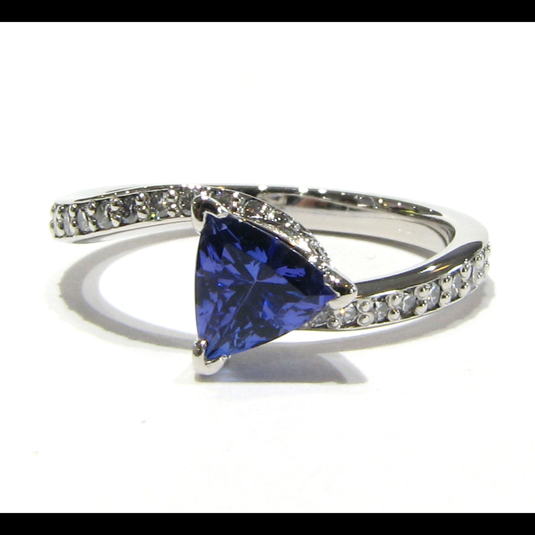 Trillion tanzanite set in twisted ring design