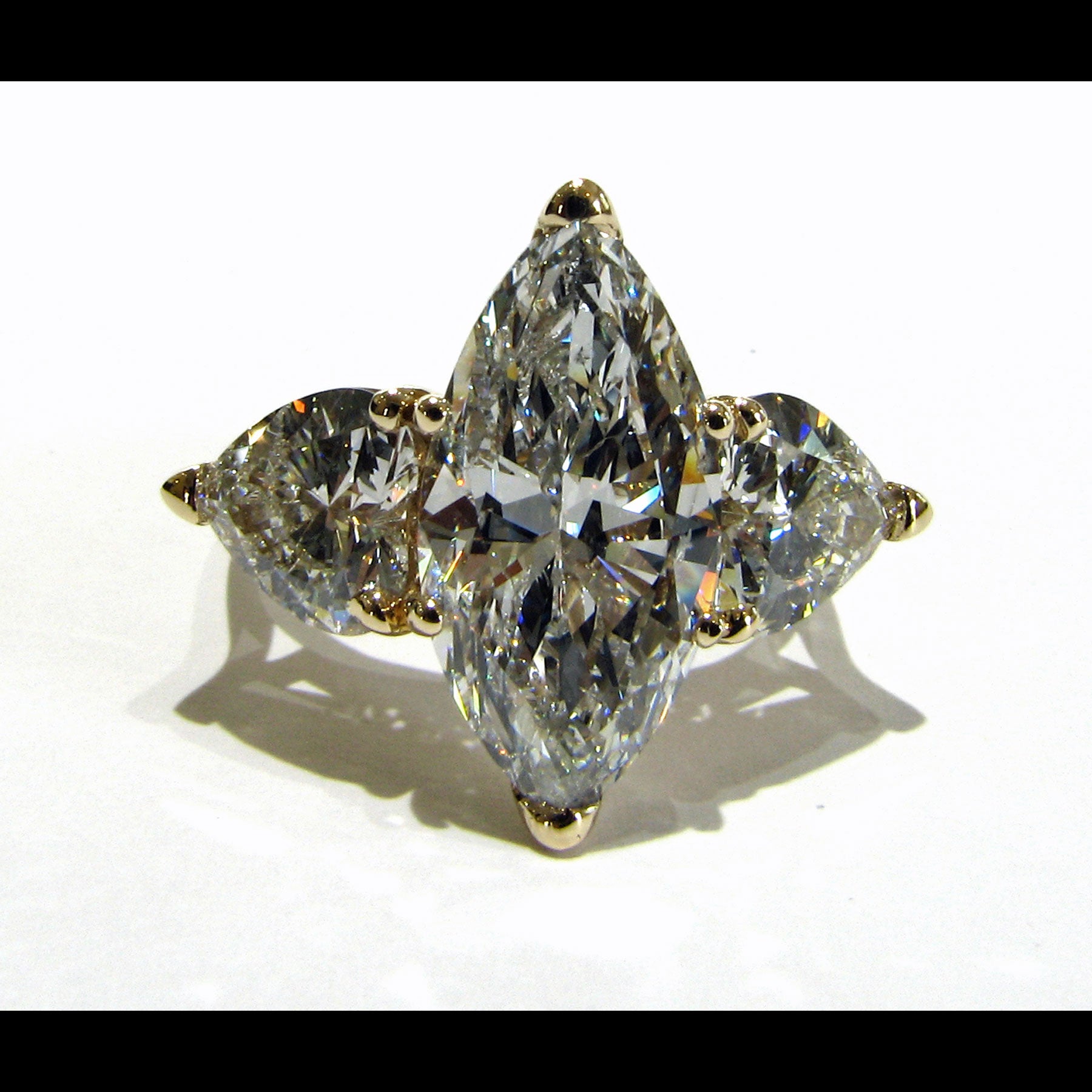 Large marquise diamond ring with heart shaped diamond side stones