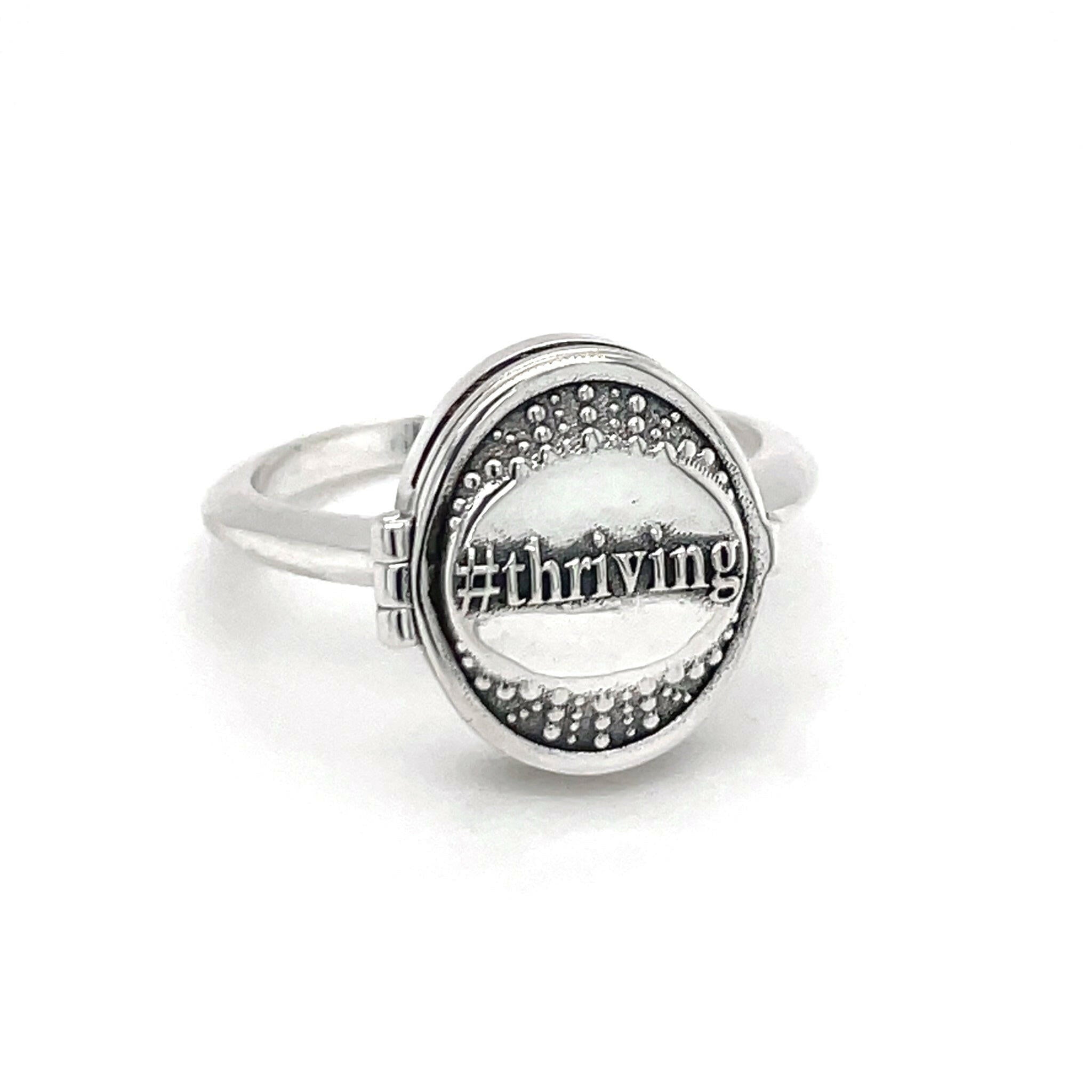 Closed #THRIVING ring front left angle. 