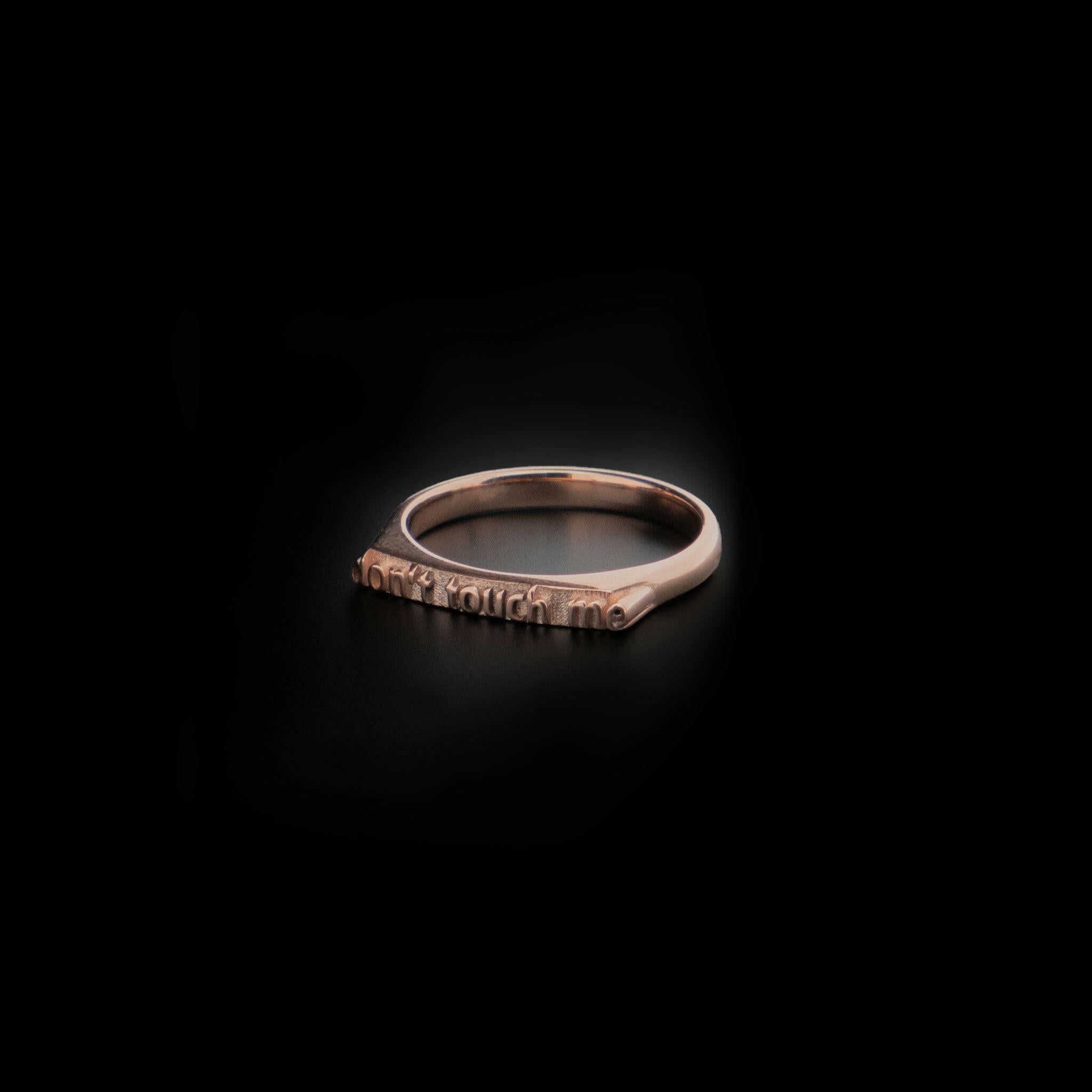 right angled 14 Karat rose gold ring with text that reads "don't touch me"