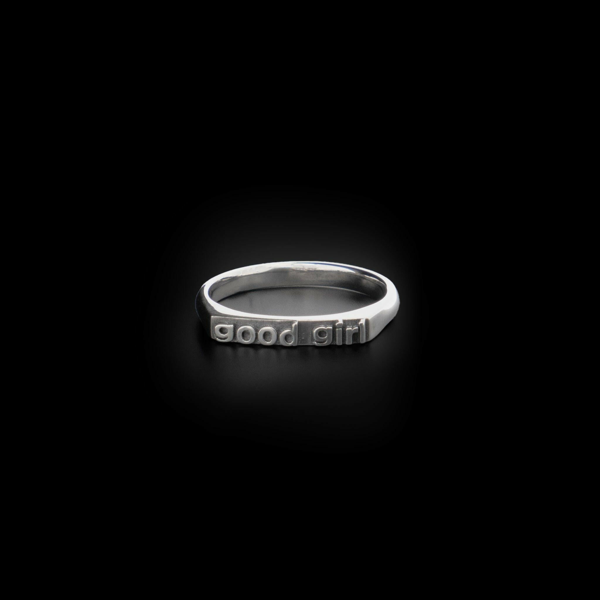 Right angle view of Sterling Silver ring that reads "good girl"