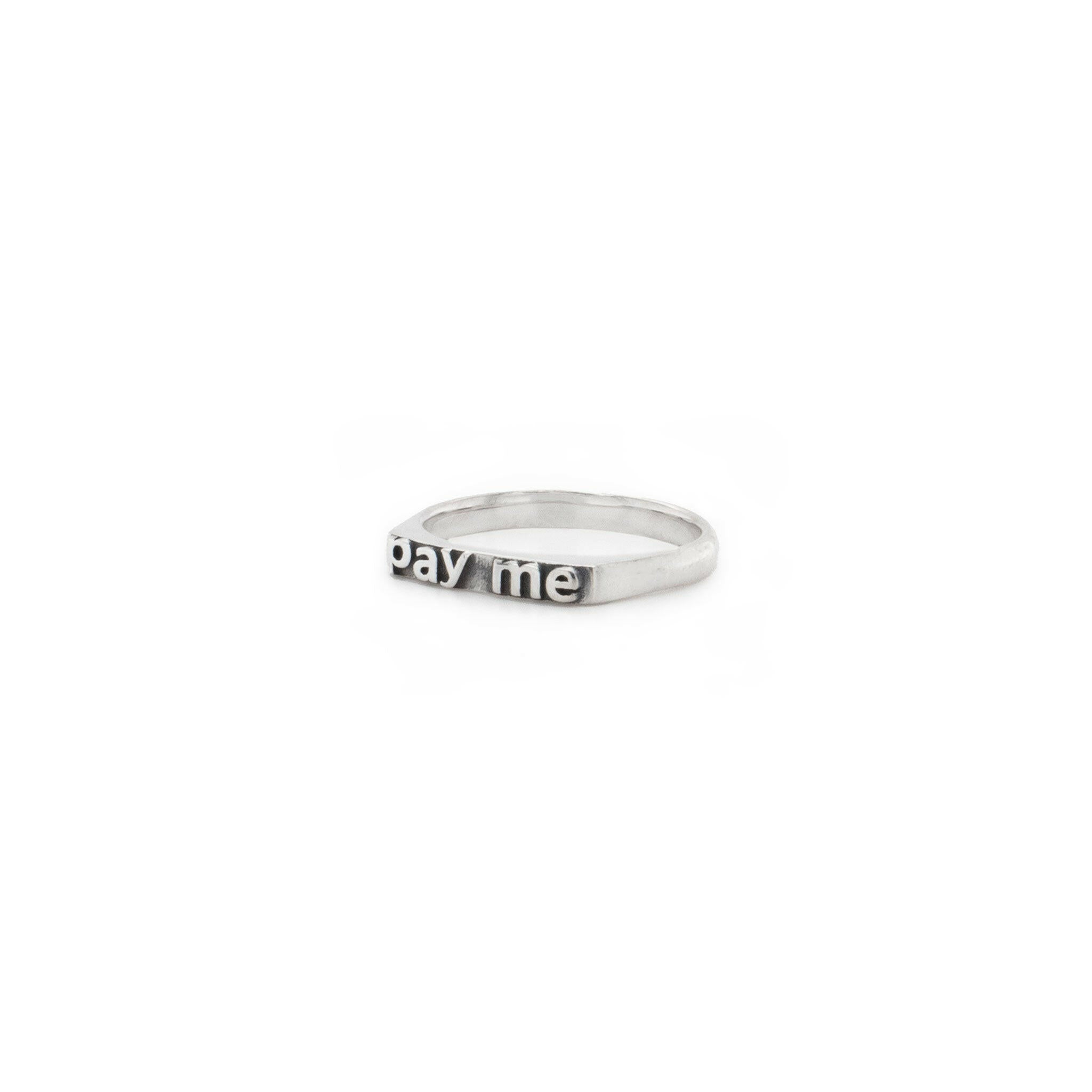 slightly right angled ring with texts that reads "pay me"