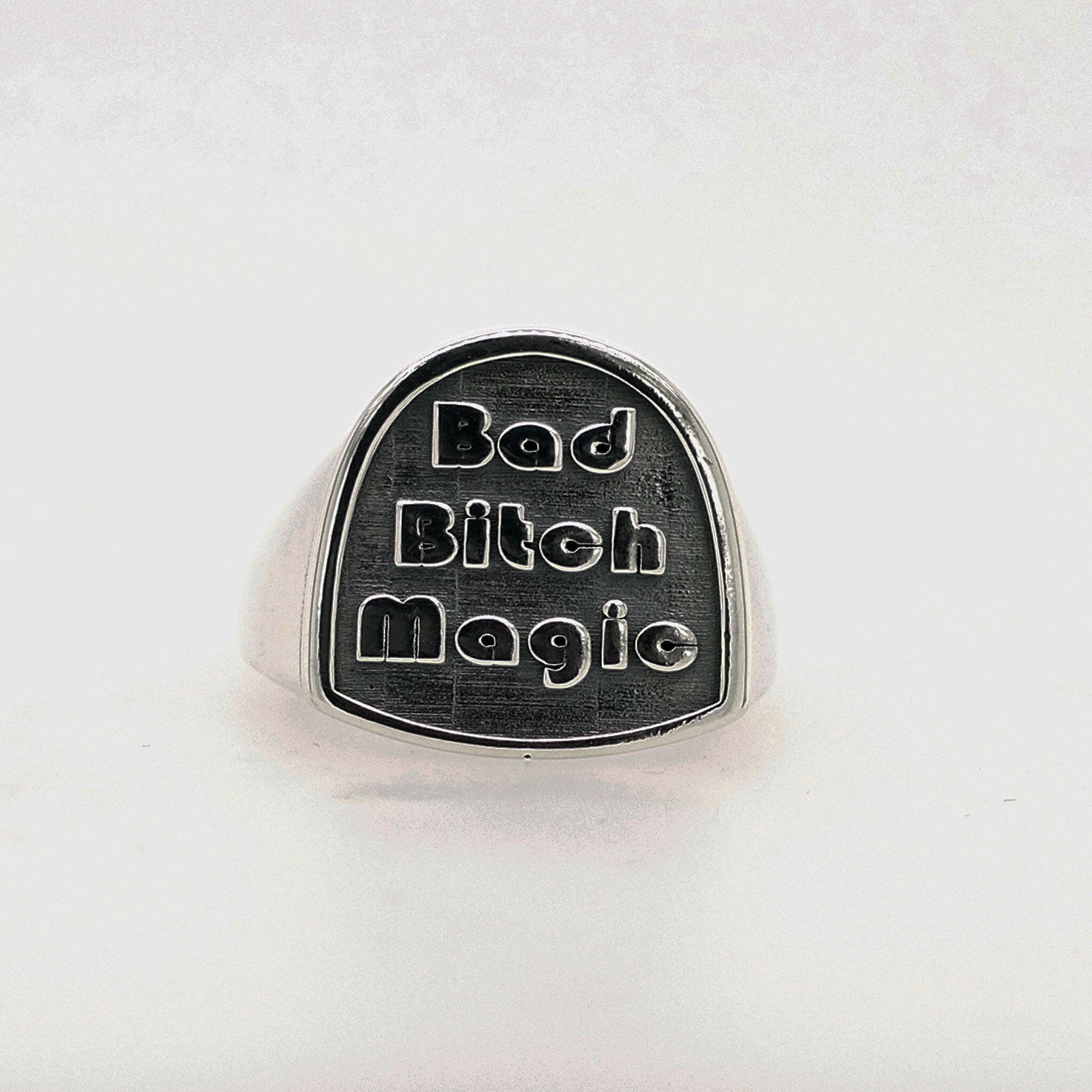 Front facing view of sterling silver ring that reads "Bad Bitch Magic"