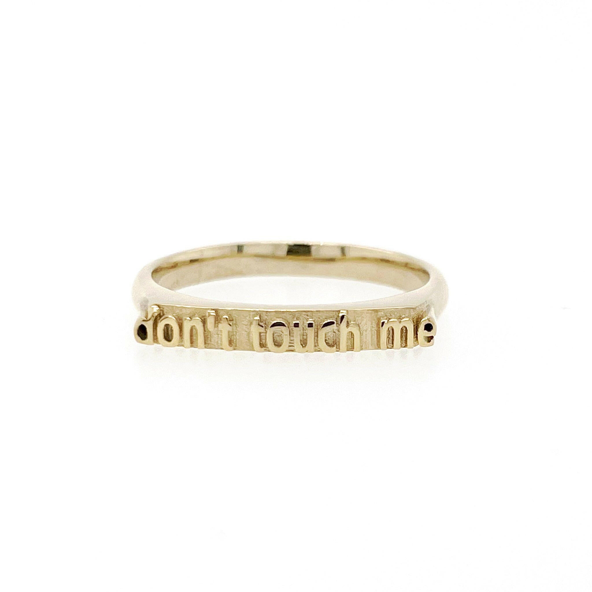 front view of 14 karat yellow gold ring with text that reads "don't touch me"