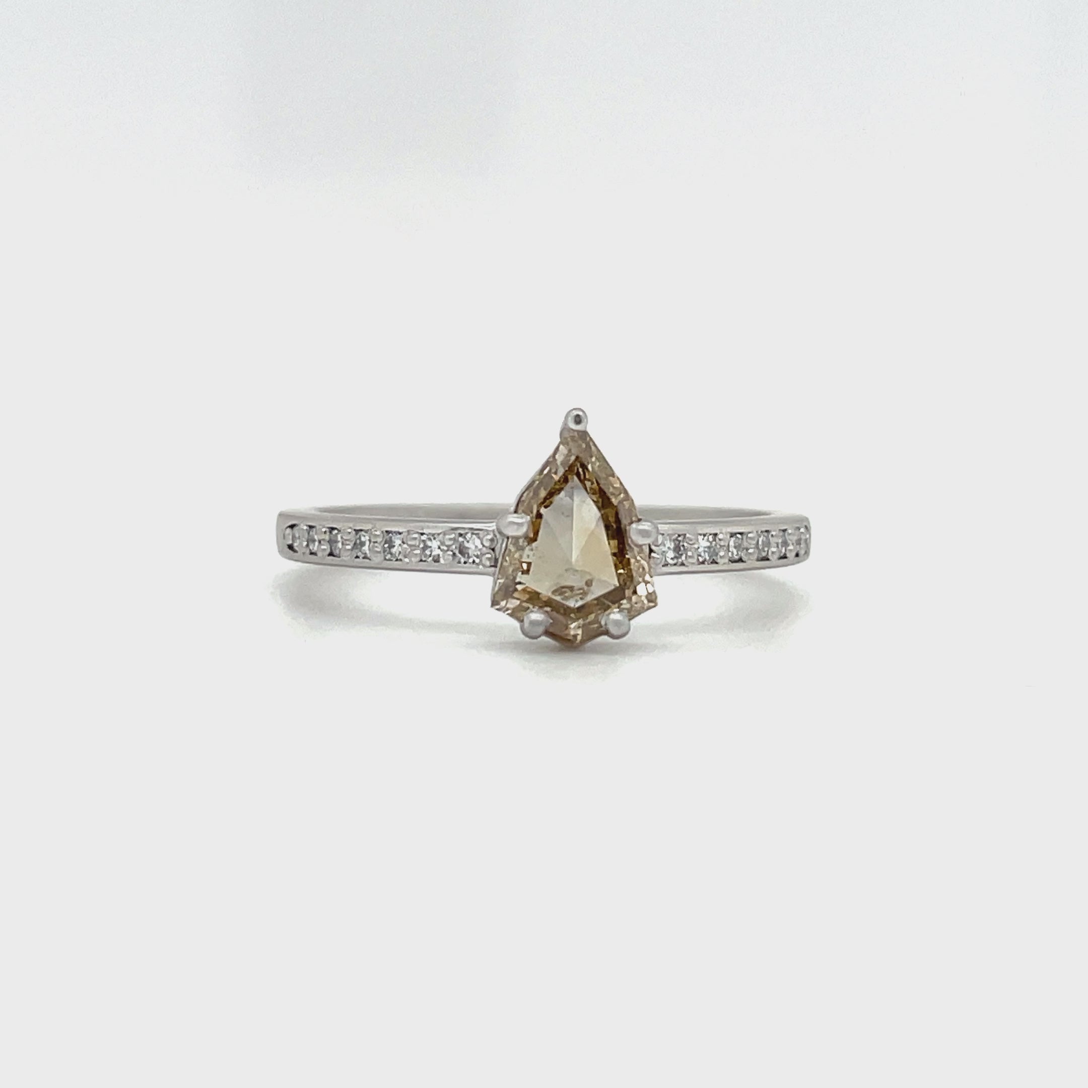 Platinum ring with shield shape champagne diamond