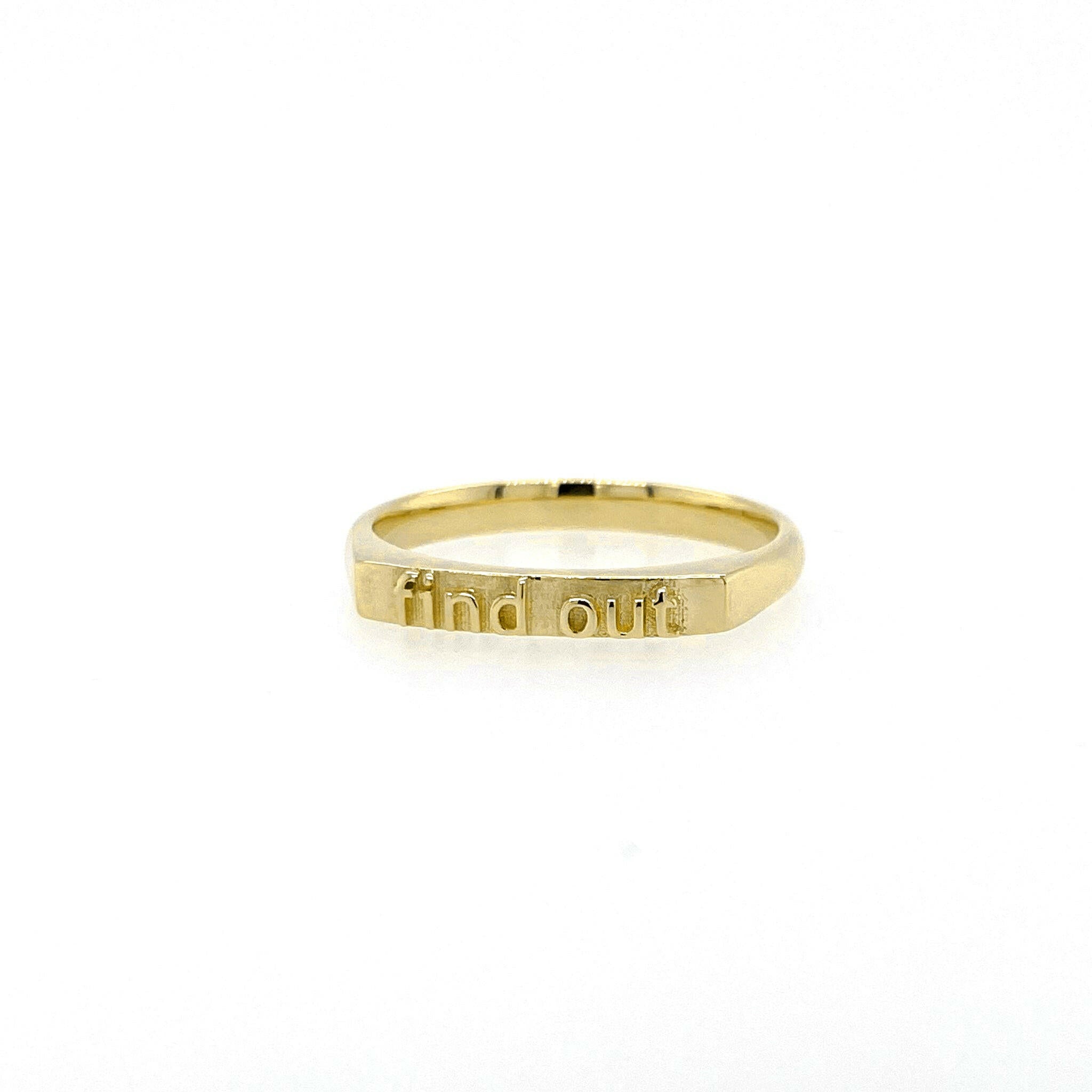 front view of 14 karat yellow gold ring with text saying "find out"