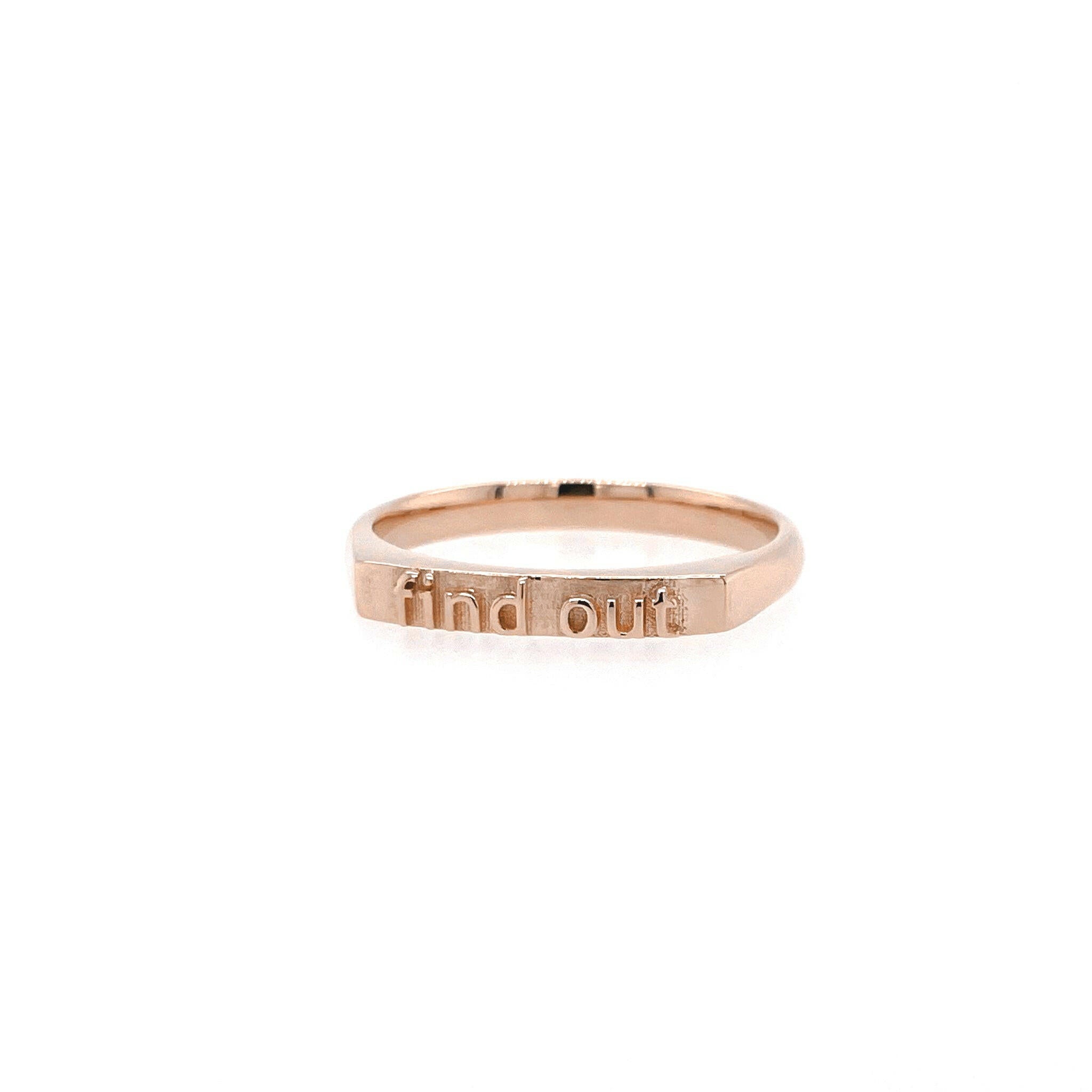 slightly right angled 14 Karat rose gold ring with text that reads "find out"