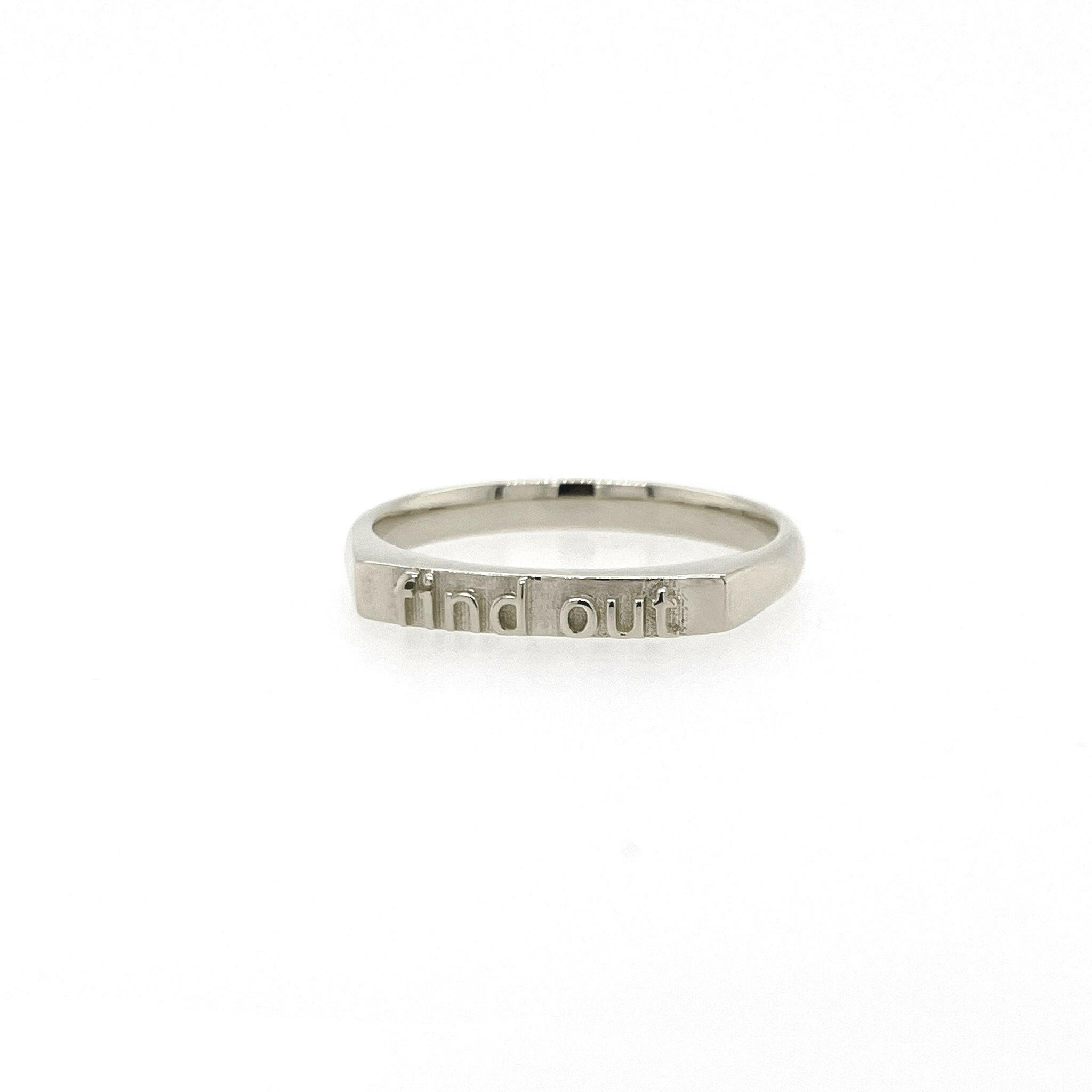 slightly right angled 14 karat white gold ring with text that reads "find out"