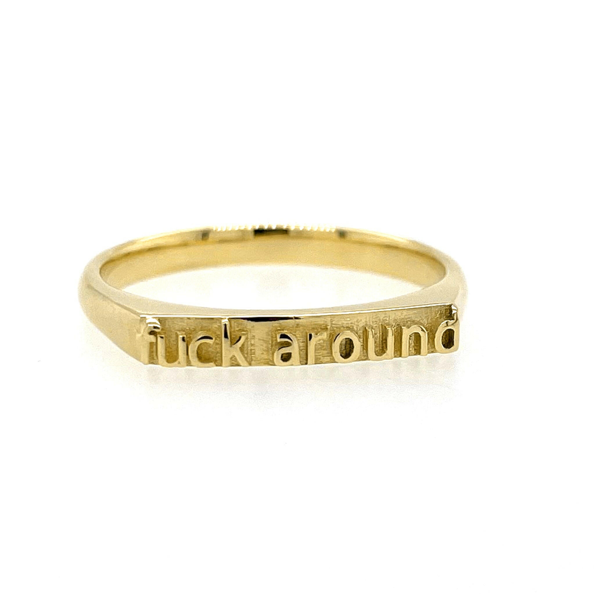 Front view of 14 Karat Gold ring that reads "fuck around" in text.