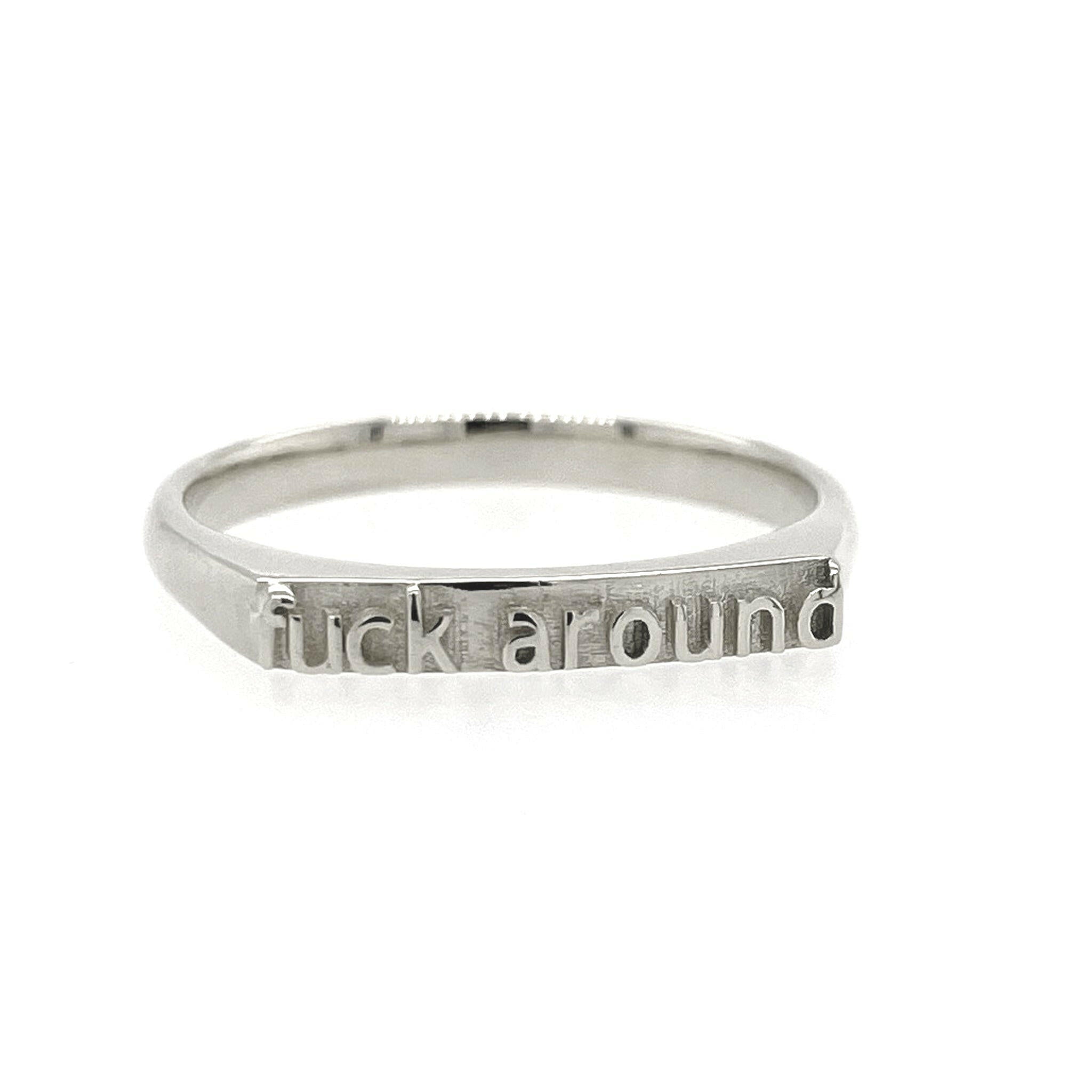 Front view of sterling silver ring that reads "fuck around" in text.