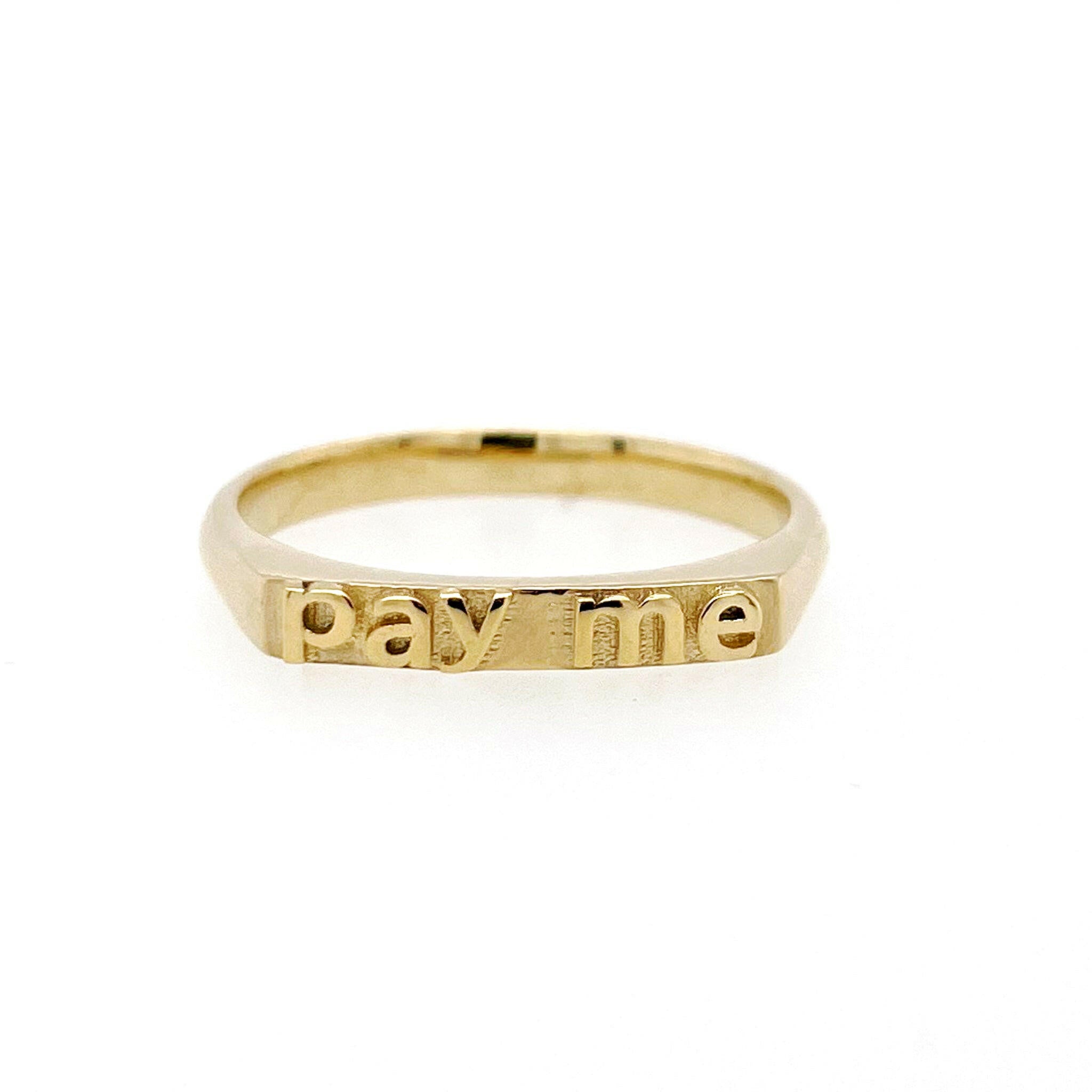 front view of  14 karat yellow gold with text that reads "pay me"