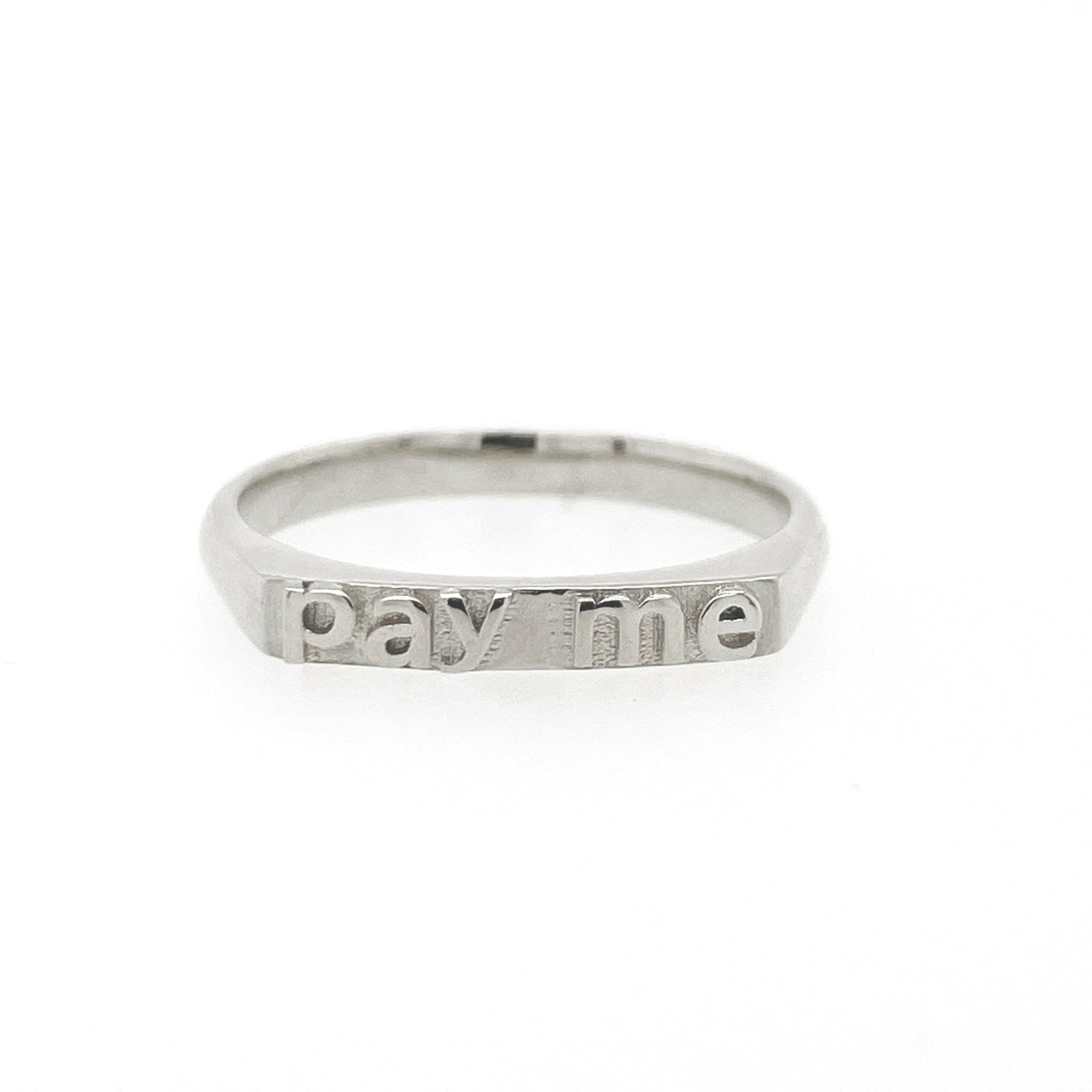 front view of 14 karat white gold ring with text that reads "pay me"